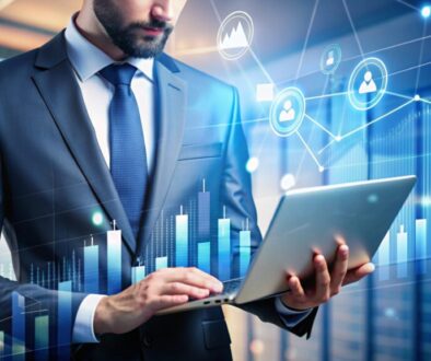 Businessman using laptop with data visualizations and charts.